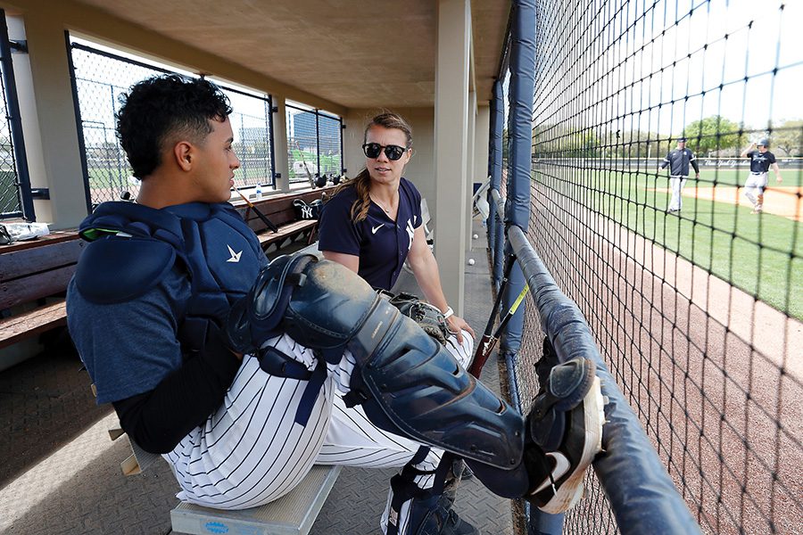 Rachel sits it dugout with a Yankee catcher