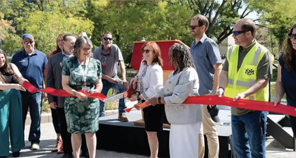 UNM President Garnett S. Stokes cuts the ribbon officially re-opening the UNM Duck Pond.