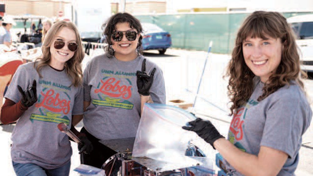 Volunteers smiling at the Albuquerque Green Chile Roast